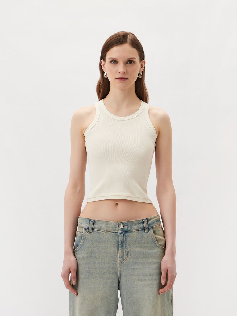 Sleeveless top with a metal logo badge