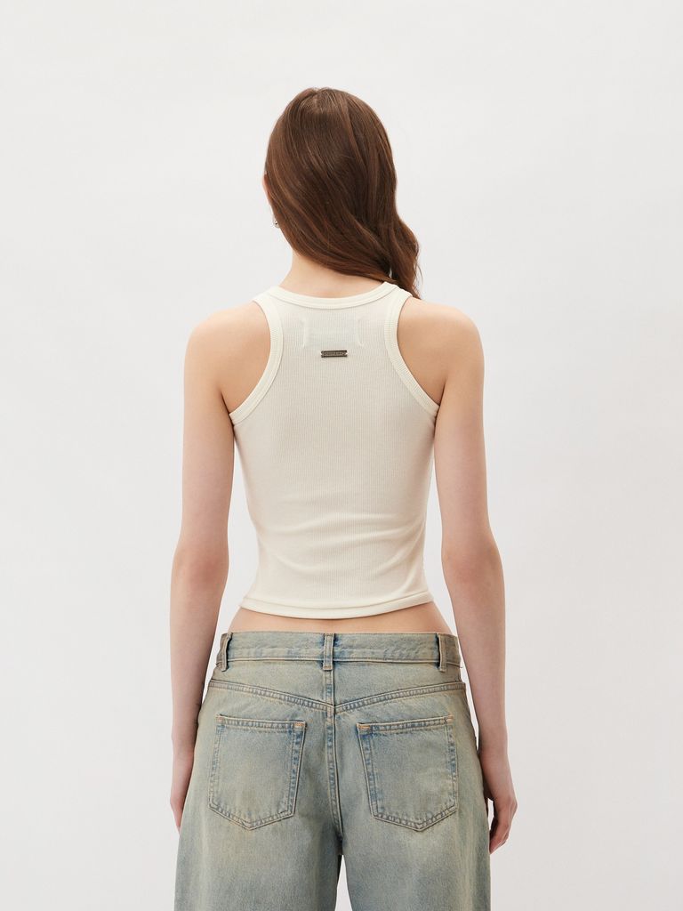Sleeveless top with a metal logo badge